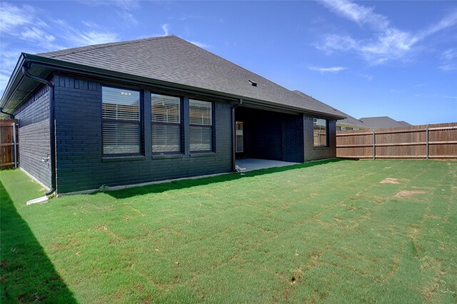 rear view of house with a yard