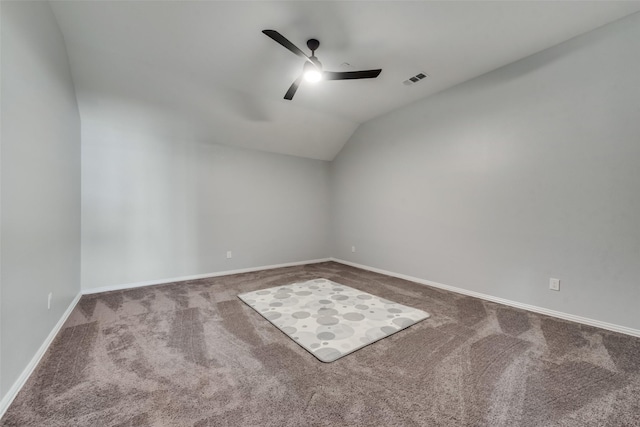 unfurnished room featuring lofted ceiling, ceiling fan, and carpet