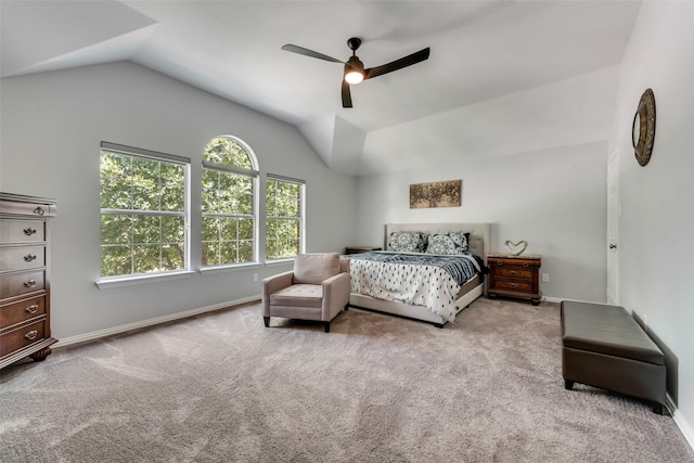 bedroom with vaulted ceiling, ceiling fan, and light colored carpet