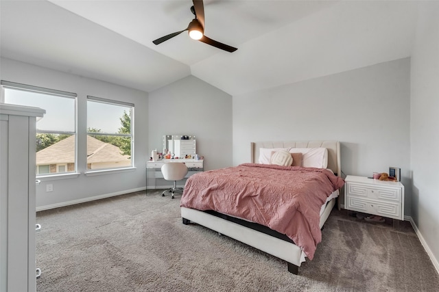 bedroom with ceiling fan, lofted ceiling, and dark colored carpet