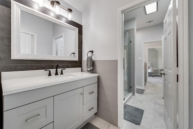 bathroom featuring vanity and a tile shower