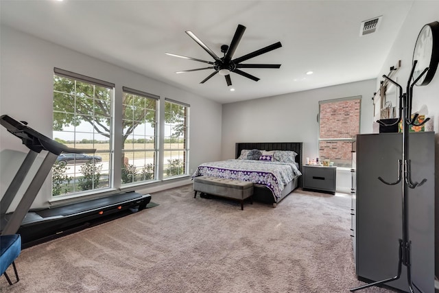 bedroom with ceiling fan and light colored carpet