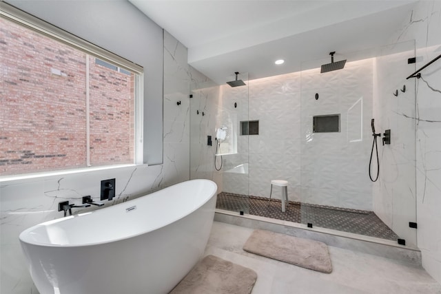 bathroom featuring plenty of natural light and plus walk in shower