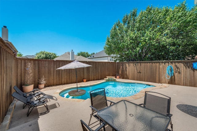 view of pool featuring pool water feature and a patio