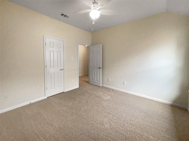 interior space with ceiling fan, a closet, lofted ceiling, and carpet flooring