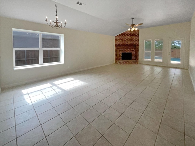 unfurnished living room with ceiling fan with notable chandelier, light tile patterned floors, a fireplace, and vaulted ceiling