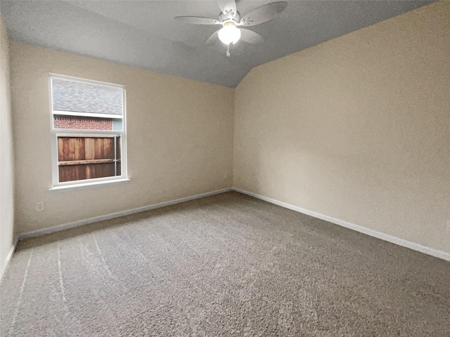 spare room with carpet, ceiling fan, and vaulted ceiling