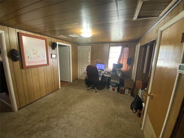 office featuring carpet and wooden walls