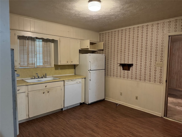 kitchen with white cabinetry, white appliances, a textured ceiling, dark hardwood / wood-style floors, and sink