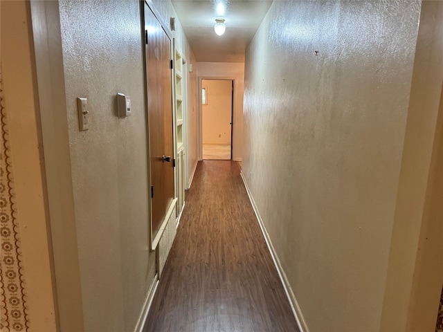 hallway featuring dark hardwood / wood-style flooring