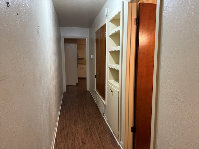 hallway with hardwood / wood-style floors