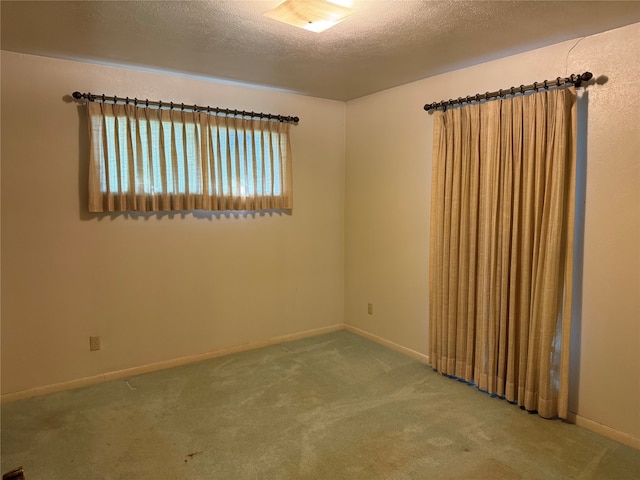 empty room featuring carpet flooring and a textured ceiling