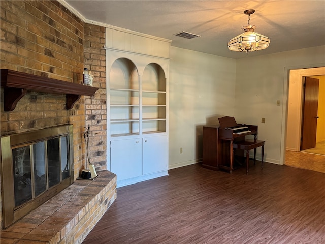 living room featuring dark hardwood / wood-style floors and a brick fireplace