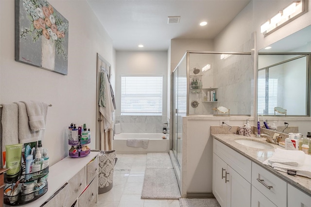 bathroom featuring vanity and separate shower and tub