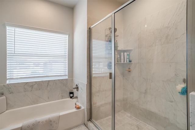 bathroom featuring a healthy amount of sunlight and plus walk in shower