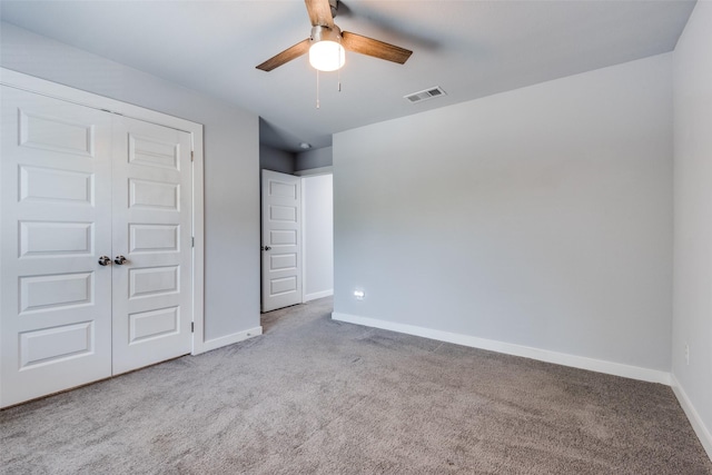 unfurnished bedroom featuring ceiling fan, carpet floors, and a closet