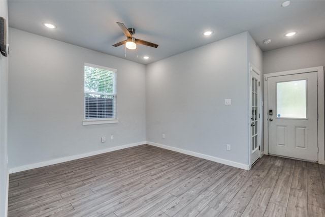 interior space with ceiling fan and light hardwood / wood-style flooring