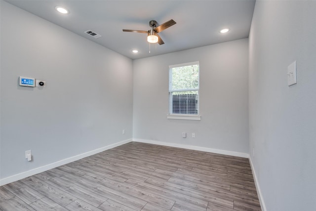 spare room featuring light hardwood / wood-style floors and ceiling fan