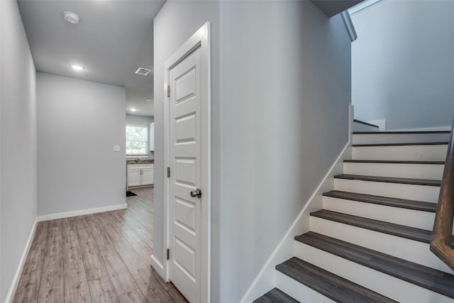 stairway featuring wood-type flooring