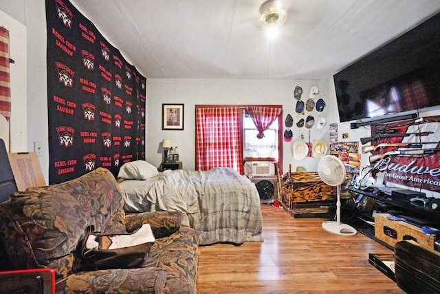 bedroom with light wood-type flooring and cooling unit