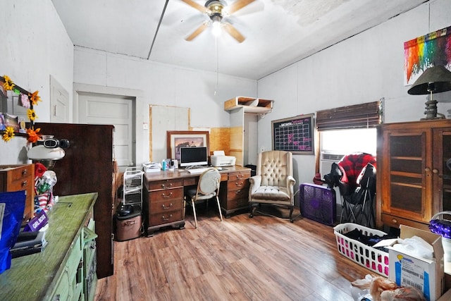 office with light hardwood / wood-style flooring and ceiling fan