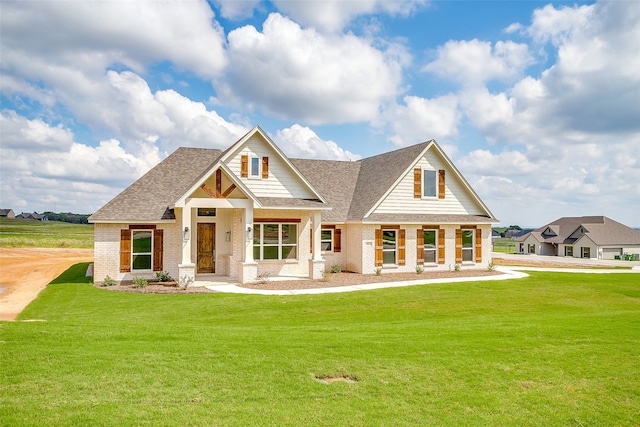 craftsman inspired home featuring covered porch and a front yard