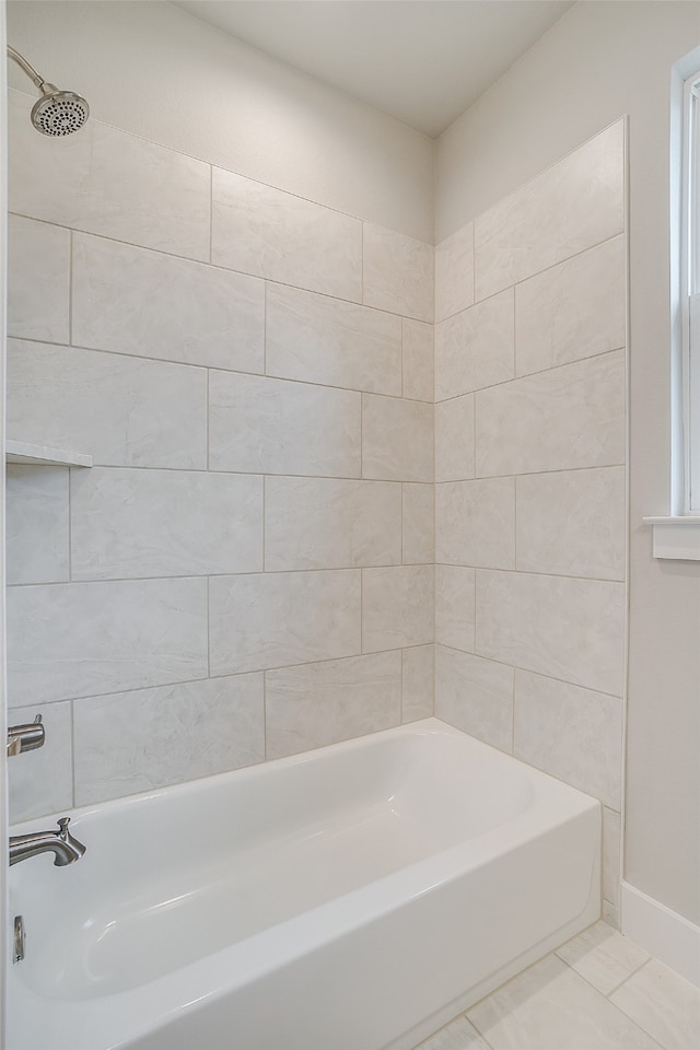 bathroom with tiled shower / bath and tile patterned flooring