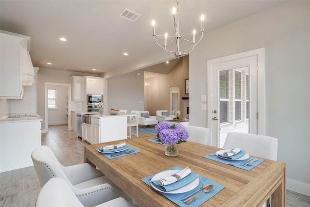 dining space featuring a chandelier and light hardwood / wood-style flooring