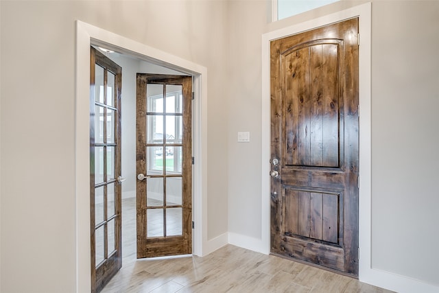 entryway featuring french doors and light hardwood / wood-style flooring