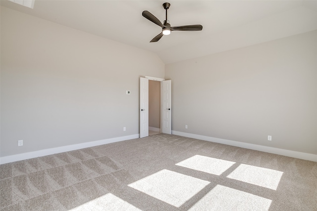 unfurnished room featuring carpet, ceiling fan, and vaulted ceiling