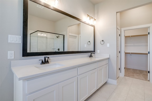 bathroom featuring walk in shower, vanity, and tile patterned floors