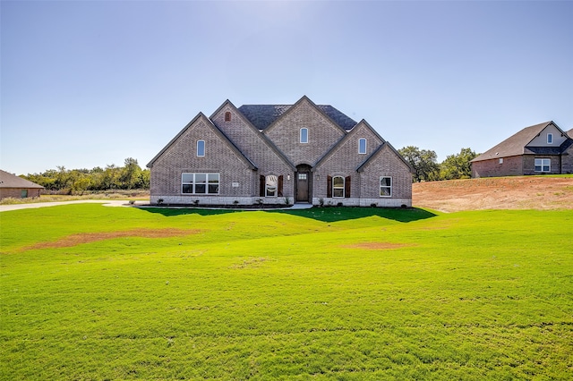 french country inspired facade with a front lawn