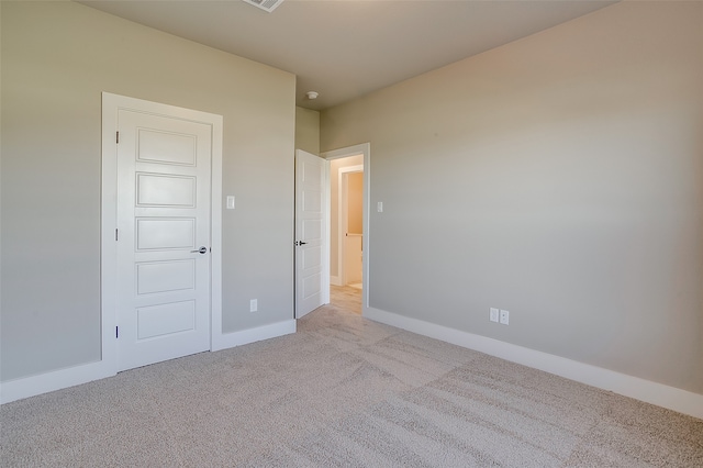 unfurnished bedroom with light colored carpet