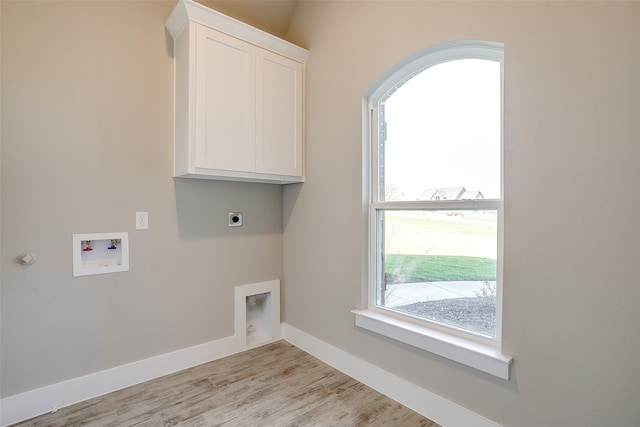 laundry room featuring hookup for an electric dryer, light wood-type flooring, washer hookup, and cabinets