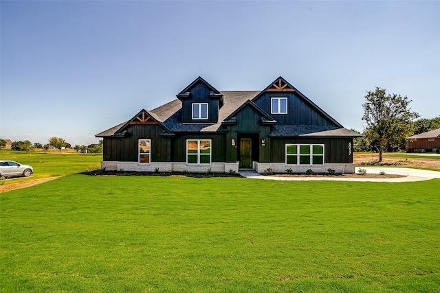 rear view of property featuring a lawn