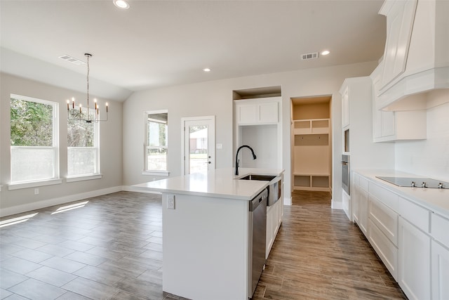 kitchen with pendant lighting, an island with sink, white cabinetry, custom exhaust hood, and appliances with stainless steel finishes