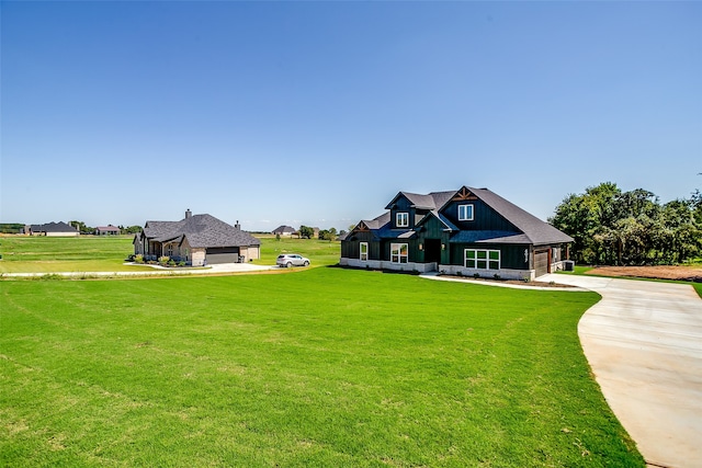 craftsman-style house featuring a front lawn and a garage