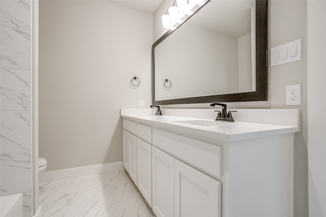 bathroom featuring vanity and toilet