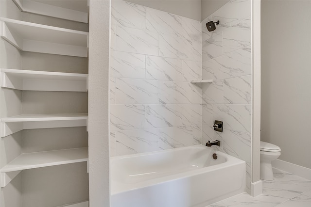 bathroom featuring tiled shower / bath and toilet