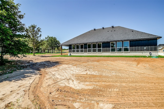 back of house with a sunroom