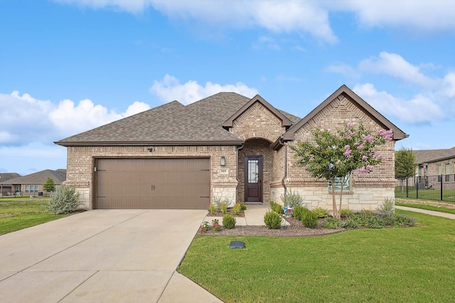 view of front of property with a garage and a front yard