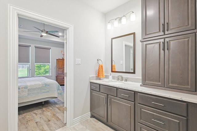 bathroom with ceiling fan, vanity, and hardwood / wood-style floors