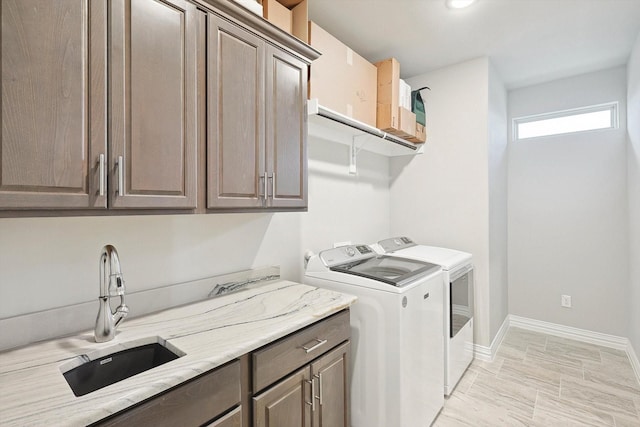 laundry room featuring sink, cabinets, and washer and dryer