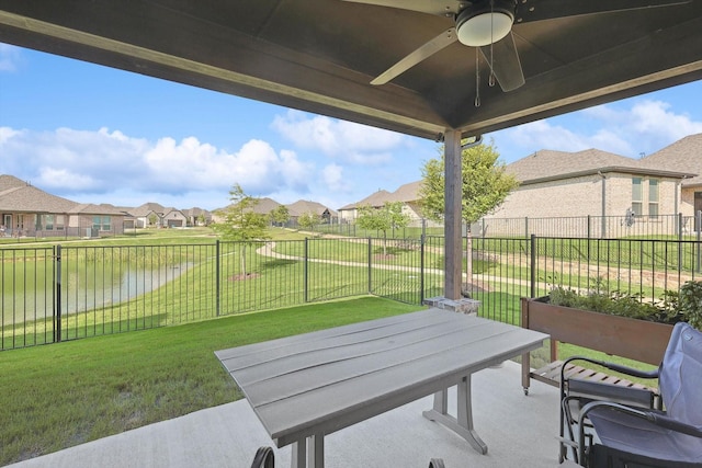 view of patio featuring a water view and ceiling fan