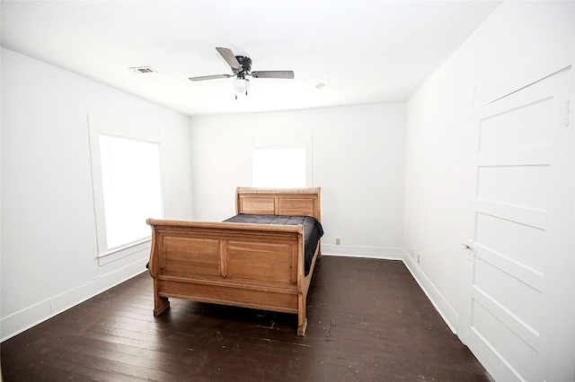 bedroom with dark hardwood / wood-style flooring and ceiling fan