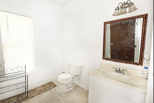 bathroom with vanity, toilet, and tile patterned floors