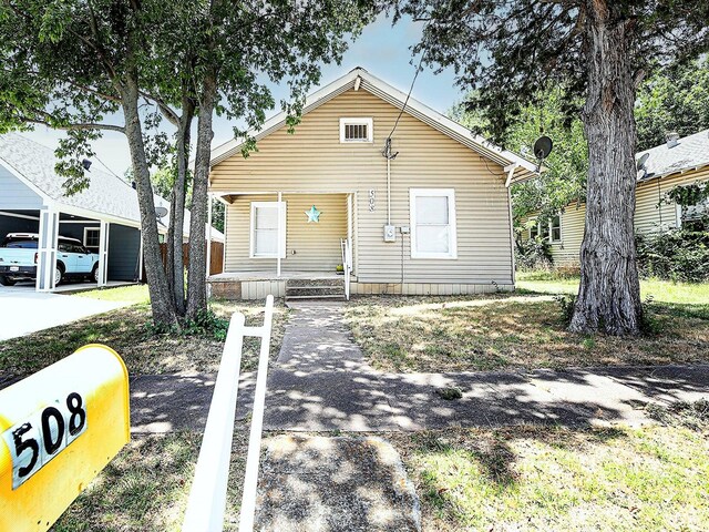 bungalow-style house with a carport and covered porch