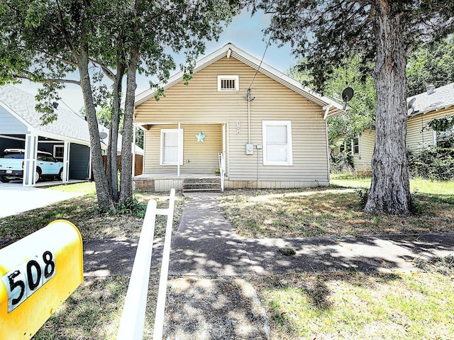 bungalow-style home with a carport