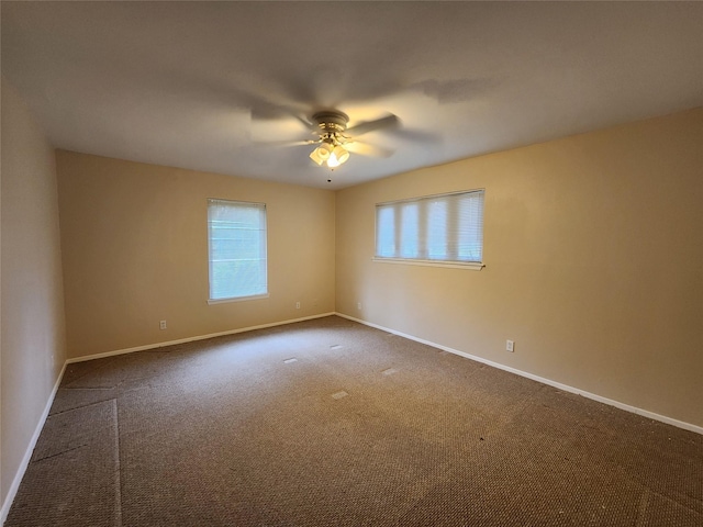 1457 Riverside Dr, West Tawakoni, TX 75474 - carpeted empty room with a wealth of natural light, baseboards, and a ceiling fan