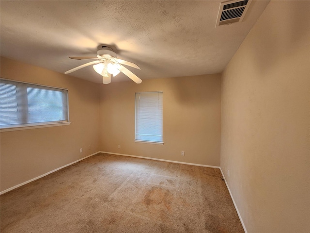 1457 Riverside Dr, West Tawakoni, TX 75474 - unfurnished room with a textured ceiling, visible vents, baseboards, a ceiling fan, and carpet floors